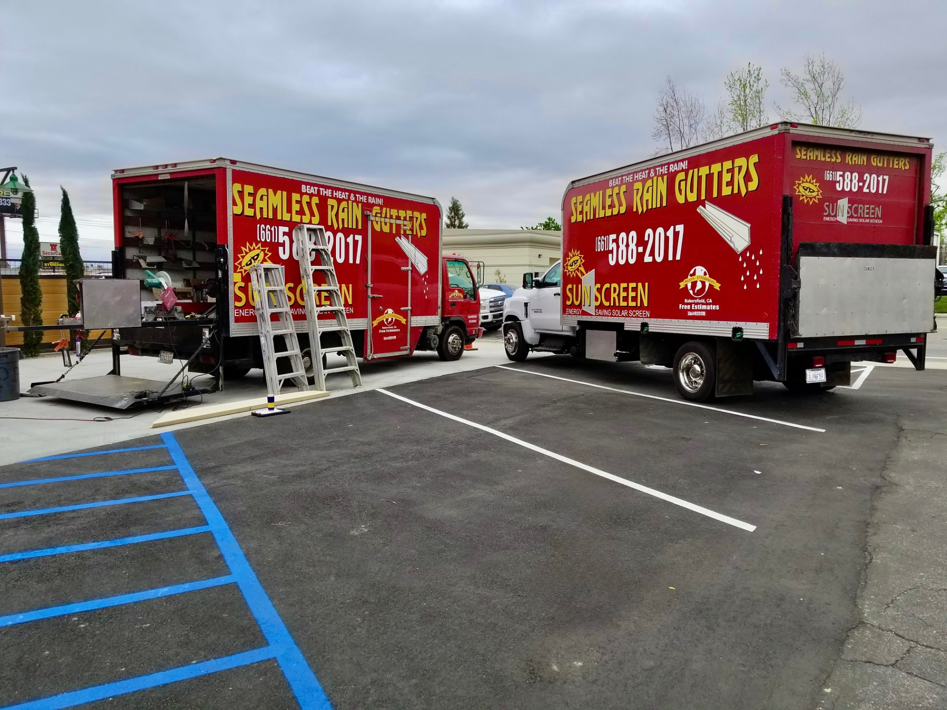 De Leon Enterprises red box truck with Seamless Rain Gutters and Sunscreen signage